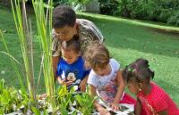 Sylvia Sullivan, head instructor at the St. Croix Montessori School, with students at the school's pond. Sylvia Sullivan, head instructor at the St. Croix Montessori School, with students at the school's pond.